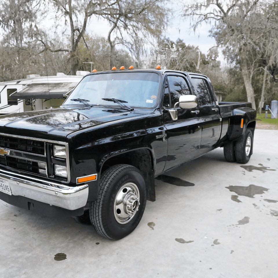 A black truck parked in a residential driveway Ceramic Coatings-D.W Automotive Details